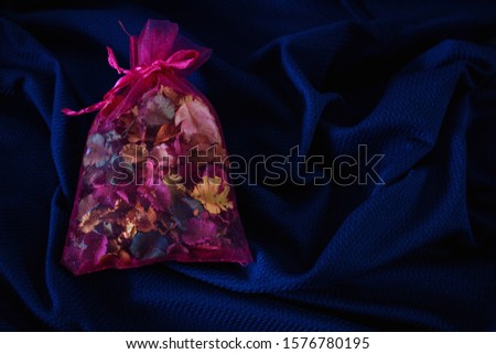 Scented bag. Reduce Musty smell in the closet space. blue cloth background 