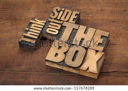 think outside the box - word abstract in letterpress wood type on a grunge wooden surface