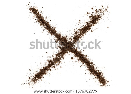Cross sign made of soil on white background.