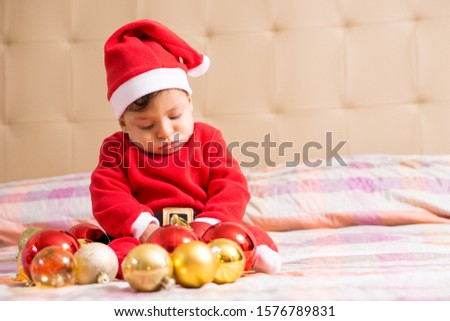 Little child wearing red Santa Claus hat, New Year celebration, winter holiday concept Royalty-Free Stock Photo #1576789831