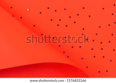 Red paper in geometric shape with glitter stars. Abstract Christmas, New year, festive background
