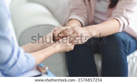 Care, trust, professionalism concept. Close up of therapist holding female patient hands, comforting her client, panorama with copy space Royalty-Free Stock Photo #1576857256