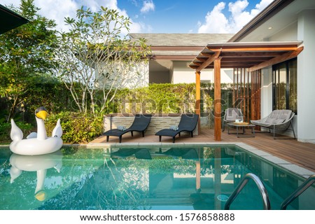luxury Swimming pool in tropical garden pool villa feature floating balloon Royalty-Free Stock Photo #1576858888
