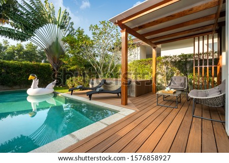 Swimming pool in tropical garden pool villa feature floating balloon Royalty-Free Stock Photo #1576858927