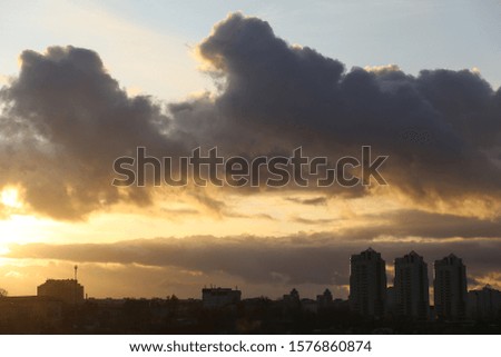 Sunset over the city and clouds