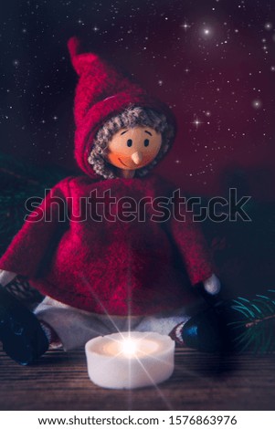 doll with candle in the Christmas atmosphere