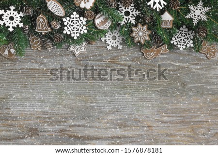 Christmas background of fir branches, ornaments, cones and snowfall effect.  Space for text.
Christmas, xmas, holiday, hygge concept.