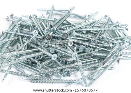 Galvanized metal screws.  45 mm screws.  Fixing materials on a white background.  A bunch of long screws. Pile of screws isolated. 