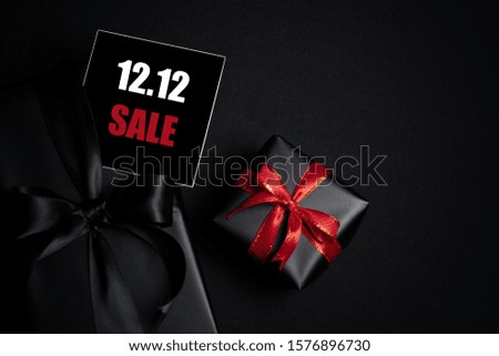 Top view of black gift box with black background with copy space for text 12.12 singles day sale. Online shopping of China, 12.12 singles day sale concept.