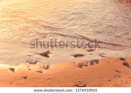 Mediterranean sea sand beach in sunset orange lighting romantic idyllic scenic view wallpaper pattern picture with empty copy space for your text here 