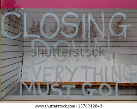 Notice written in white on the window of a closing, bankrupt shop reading "Closing down sale. Everything must go", a symbol of austerity and recession in the UK