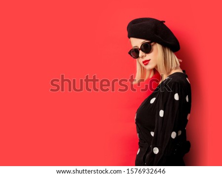 beautiful french woman in beret on red background
