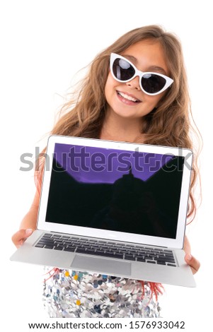 Little pretty caucasian girl with sunglasses and laptop, picture isolated on white background