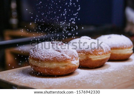Hanukkah food doughnuts with jelly and sugar powder with bookeh background. Jewish holiday Hanukkah concept and background. Copy space for text. Shallow DOF Royalty-Free Stock Photo #1576942330