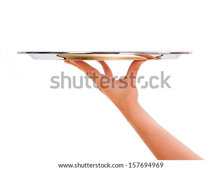 Woman hand holding an empty silver salver Royalty-Free Stock Photo #157694969