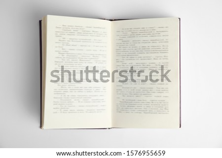 Open book on white background, top view. Space for text Royalty-Free Stock Photo #1576955659