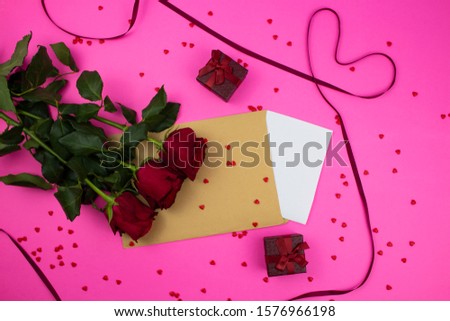 
Red roses on a pink background. red hearts on the background. the tape is red. St. Valentine's Day.  .very beautiful roses. copyspace