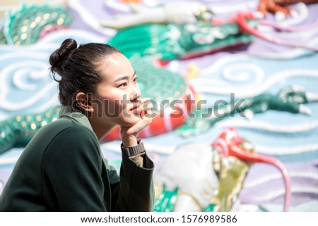 side view of beautiful young portrait with sunlight over her face, blurry background, close up, soft focus
