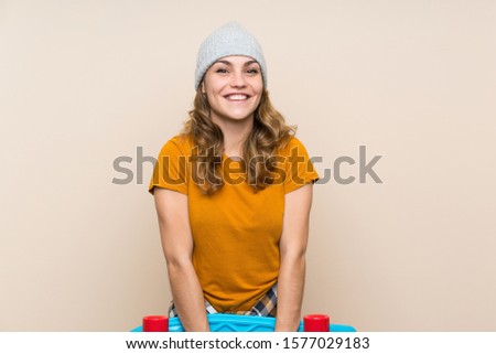 Young skater blonde girl over isolated background