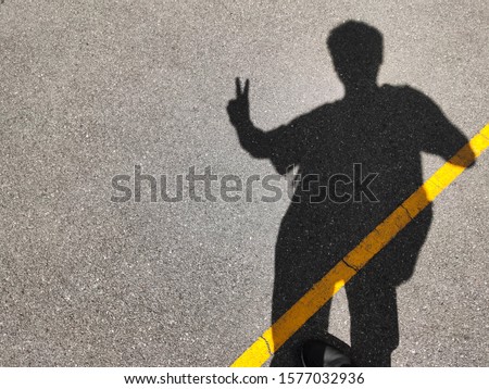 A man and peace finger sign shadow 