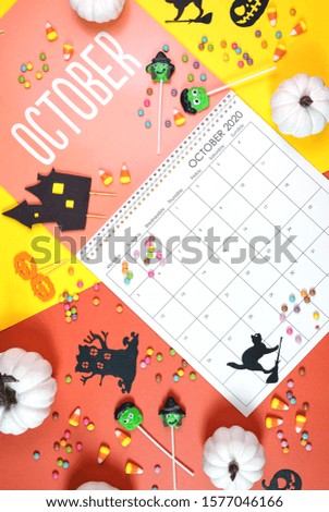 On-trend 2020 calendar page for the month of October modern flat lay with seasonal food, candy and colorful decorations in popular pastel colors. Vertical. One of a series for 12 months of the year.
