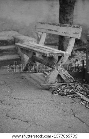 Old wooden bench with peeling paint, bw photo