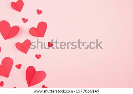 Paper hearts over the pink pastel background. Abstract background with paper cut shapes. Sainte Valentine, mother's day, birthday greeting cards, invitation, celebration concept Royalty-Free Stock Photo #1577066149