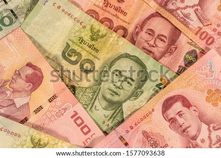 A composition of Thai baht. THB banknotes providing great options to be used for illustrating subjects as business, banking, media, etc. Royalty-Free Stock Photo #1577093638