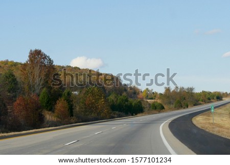 Paved roads with colorful trees in autumn along Interstate 49, Arkansas.