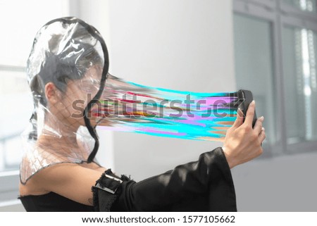 Young girl making selfie. Concept of humanity being sucked into smartphones. Graphic Processing.