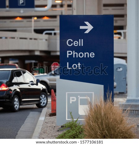 Cell Phone parking lot sign at a busy airport 