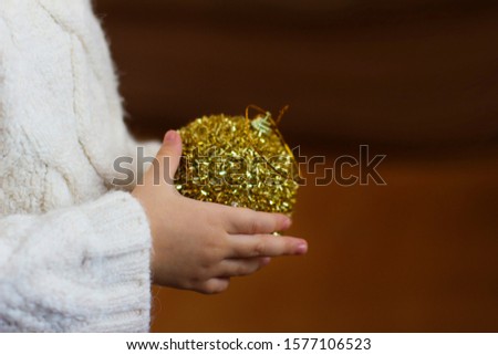 christmas ball in hands. christmas toy in hands	