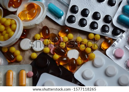 Vitamins and cod liver oil. Nutrition pills. Colored pills and capsules. Healthy lifestyle and healthcare concept photo.