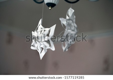 Paper 3d snowflakes hanging on the ceiling close-up