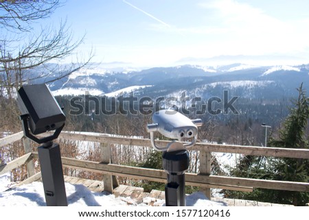 Binocular on observation deck on the top of snow mountains viewpoint. Winter nature scenic panorama landscape,travel.