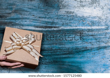 Christmas and New Year gift box on wood background. Top view with copy space.