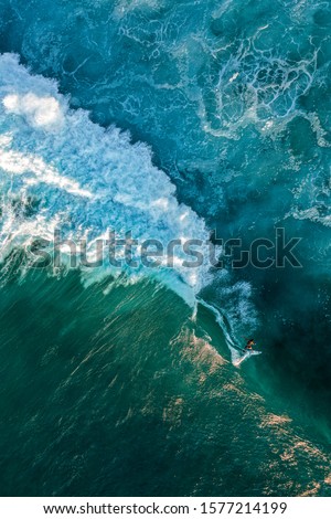 Sunset Aerial Shot of a Wave and a Surfer in Pipeline spot on North Shore Oahu, Hawaii 
