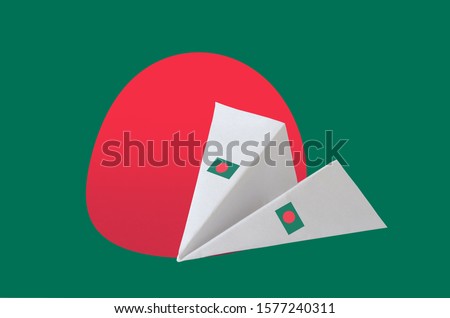 Bangladesh flag depicted on paper origami airplane. Handmade arts concept