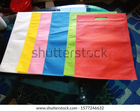 Non Woven Eco Friendly Bags on Green Grass Background. Shopping & Gift Bags