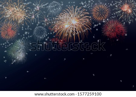 Colorful Fireworks against dark background with free space for text or label about celebration or anniversary concept