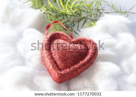 Red christmas ornaments, heart and ball, on the xmas tree