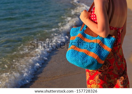 woman with beach bag at the sea, holiday concept 