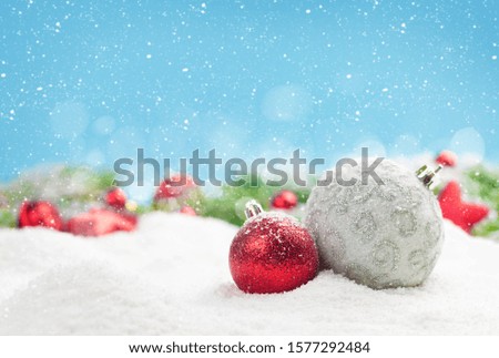 Christmas greeting card with decor in snow over blue background and copy space for your xmas greetings