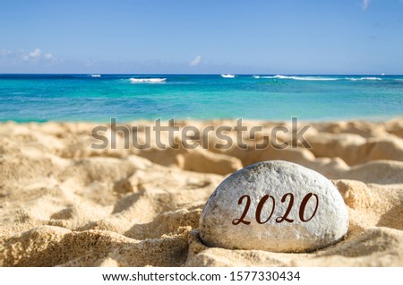 Symbol from number 2020 on the sandy beach near ocean in Hawaii, Kauai 