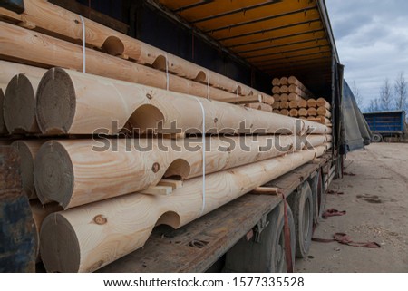 logs for building a house in the car