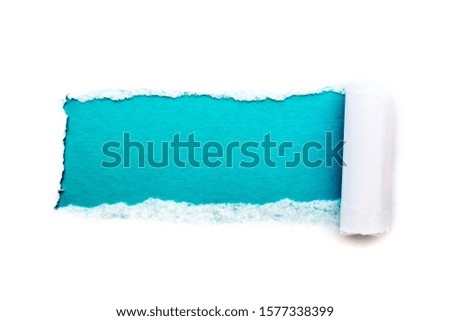 A hole in white paper with torn edges isolated on a white background with a light blue color paper background inside. Good paper texture