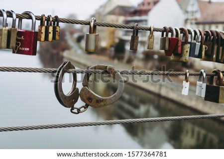 Many padlocks hang on the railing of the bridge for demonstrate symbol of eternal love. Selective focus.