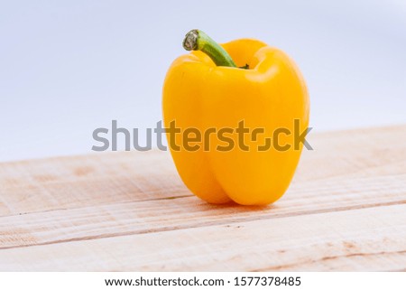 Colorful peppers placed on a wooden table
