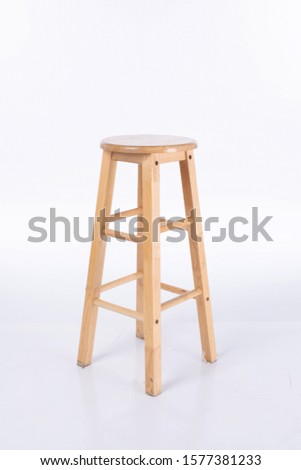 A wooden chair on a white floor