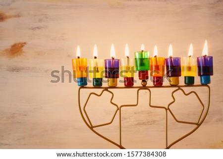 Religion image of jewish holiday Hanukkah background with menorah (traditional candelabra) and colorful oil candles